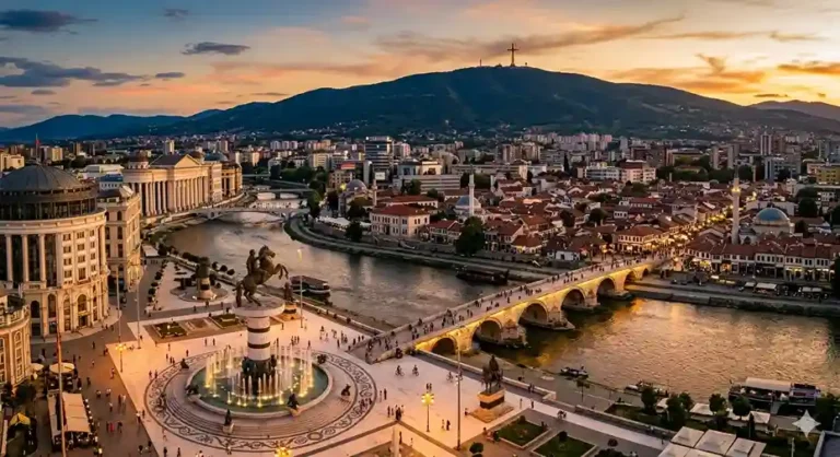 Aerial view of Skopje city center at golden hour with the Stone Bridge, Vardar River, and Macedonia Square