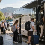 Travelers boarding an intercity bus for the Tirana to Saranda route in Albania.